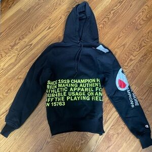 Champion Black Hoodie with Neon Yellow Graphic and Accent Blue/Red Sleeve Logo